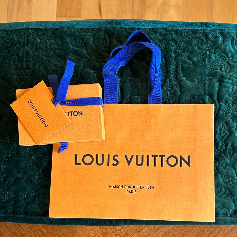 Authentic Louis Vuitton paper box and bag with gift tag and ribbon.